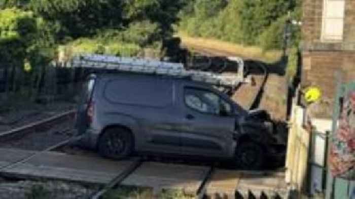 Van collision at level crossing closes railway line