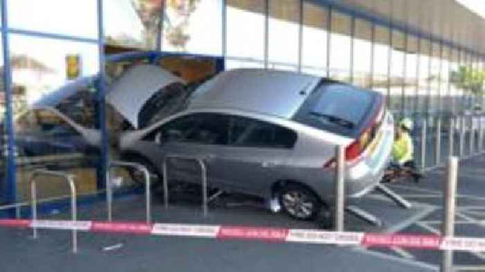 Supermarket closed after car crashes through window