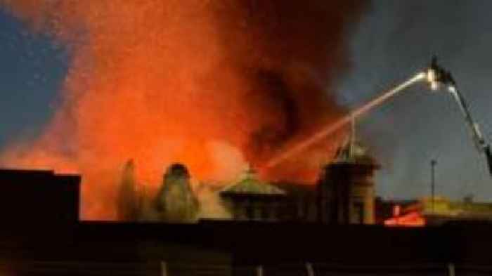Crews battle overnight fire which spread across shops
