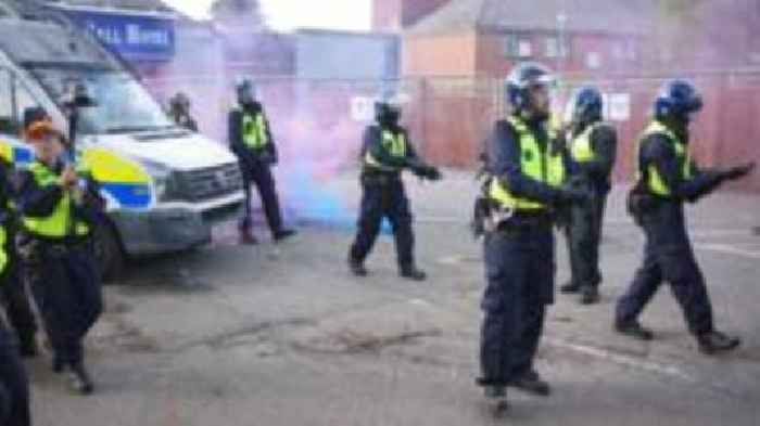 Bottles and smoke flares thrown in hotel protest