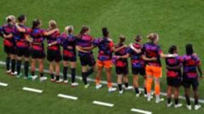 England players and subs stand in support of Carter