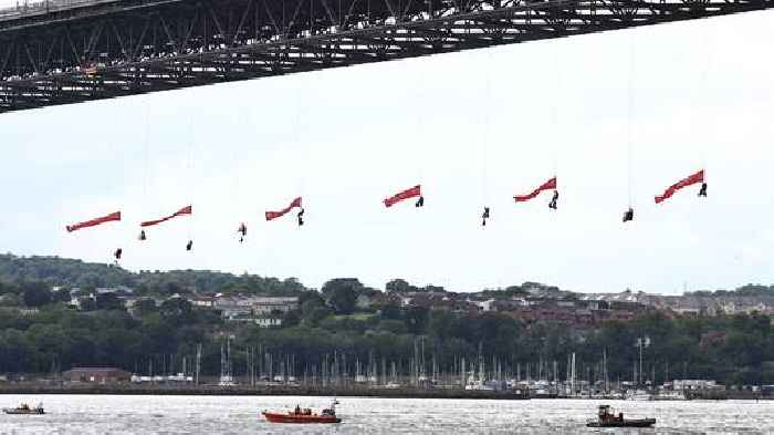 Ten Greenpeace activists arrested after suspending themselves from bridge