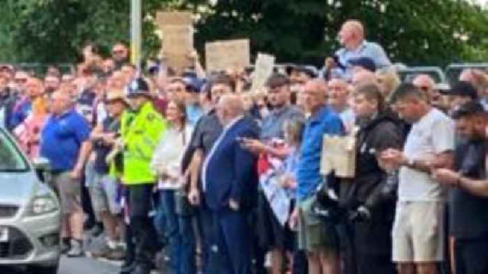 Two men charged after asylum hotel protest