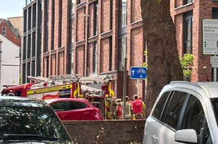 Live: Water pours from block of flats as emergency services rush to scene