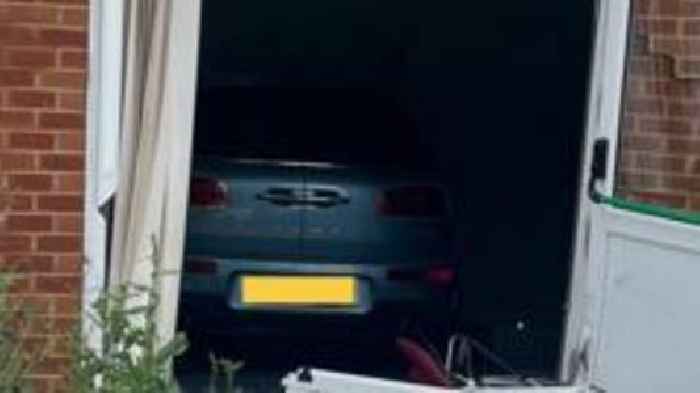 Car crashes through doors and into community hall