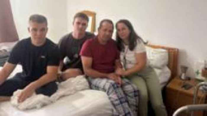 Ukrainian family forced to lift father down stairs