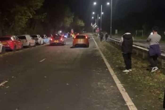 Crowds line one of Wales' main roads to watch illegal drag racing