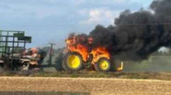 Fire crews rescue driver after tractor catches fire