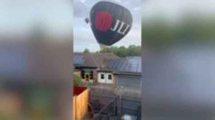 Hot air balloon taking part in fiesta hits primary school