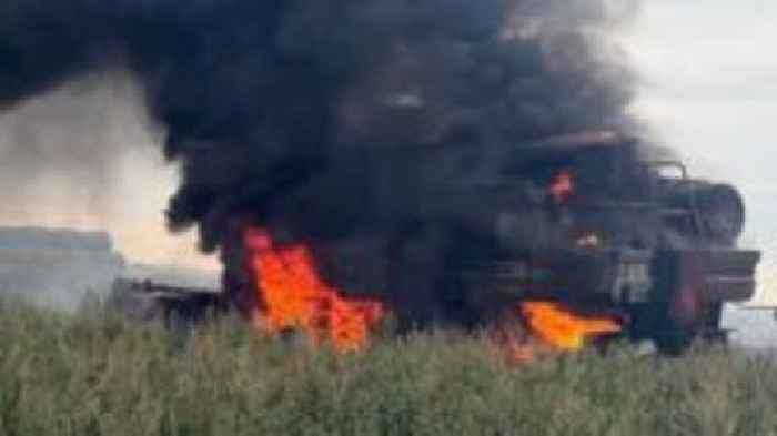 Combine harvester engulfed in flames