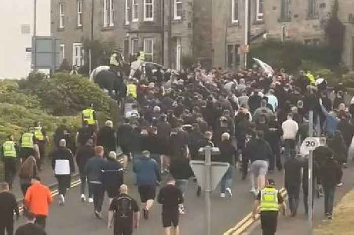 Hundreds of Scots football fans in black escorted to powderkeg fixture by cops