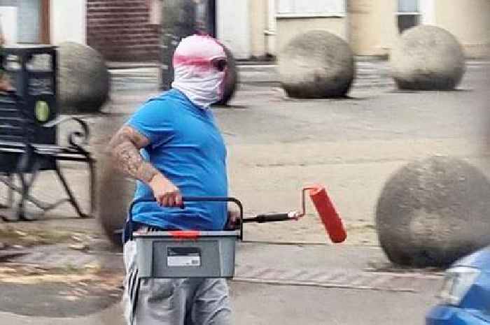 Men in St George's masks caught on camera painting England flags on roundabouts