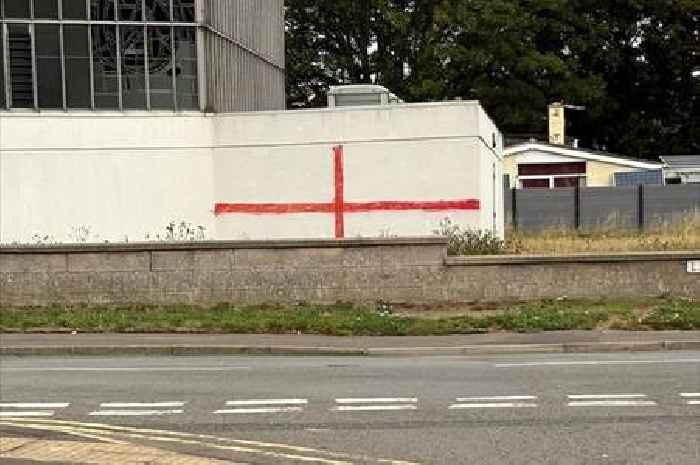 Vicar scrubs off St George's Cross painted on church wall