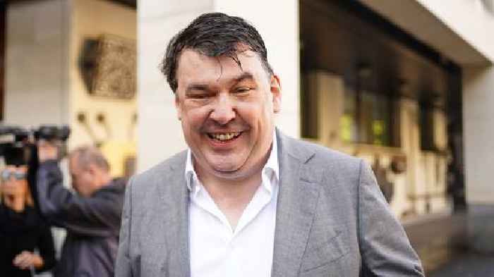 Father Ted co-creator arrives for trial charged with harassing transgender activist