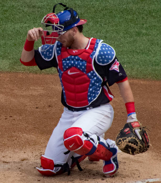 Catcher plays for both teams in same game