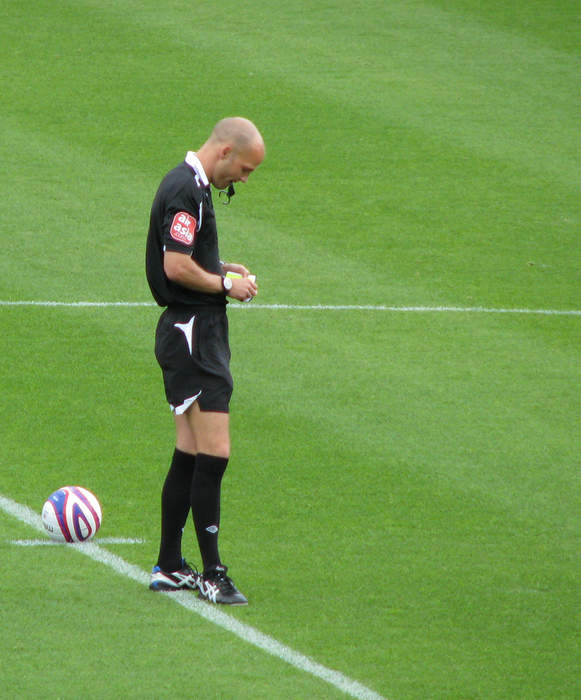 Referee locks heads with Ipswich player