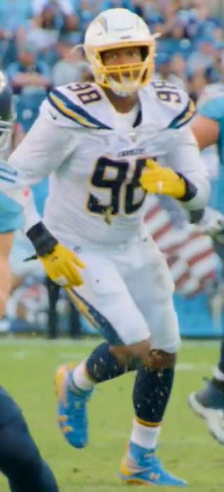 NFL player passes out food to families
