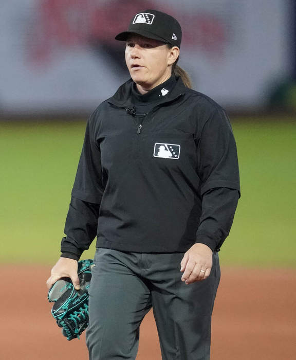 Standing ovation as first female umpire for Major League Baseball takes to the pitch