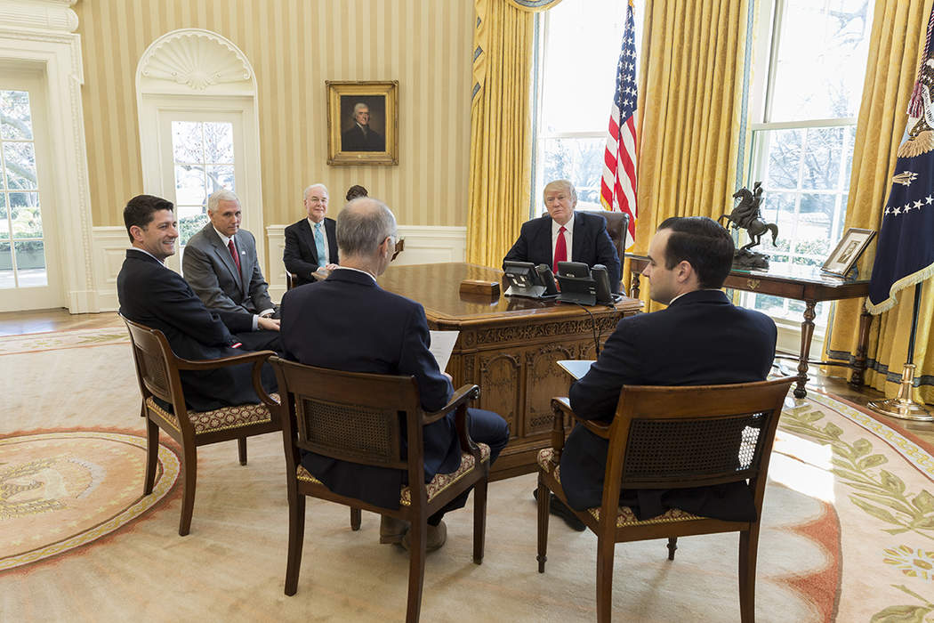 In the Oval Office for the first time as president, Biden begins to roll back Trump’s legacy.