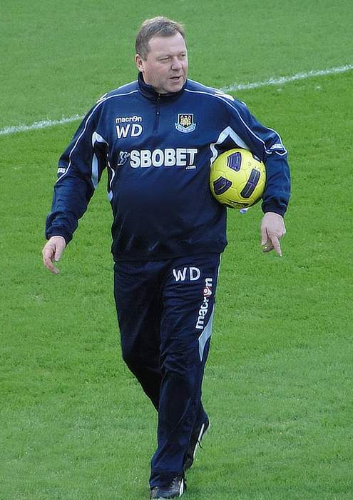 Wally Downes: AFC Wimbledon suspend manager after betting charge