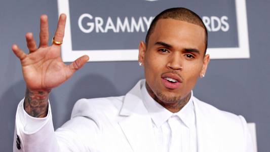 Rapper charged with GBH - after singer Chris Brown remanded in custody over 'bottle attack'